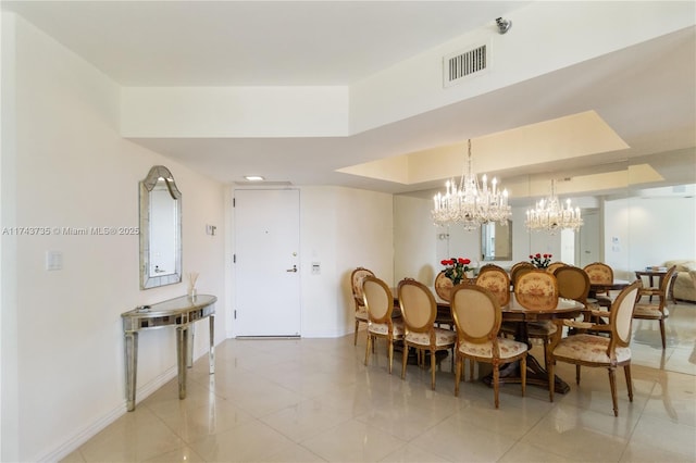 tiled dining area featuring a tray ceiling