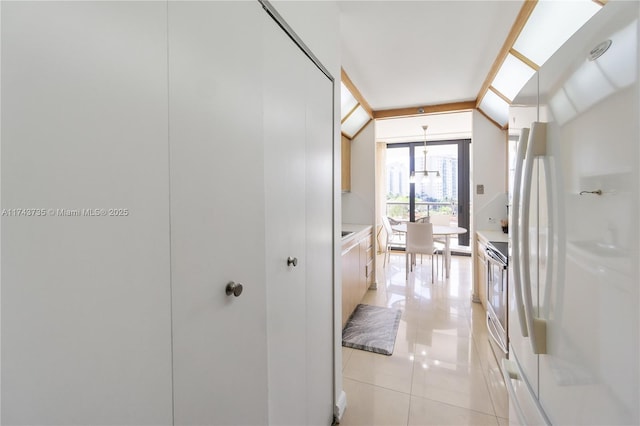 hall featuring light tile patterned floors