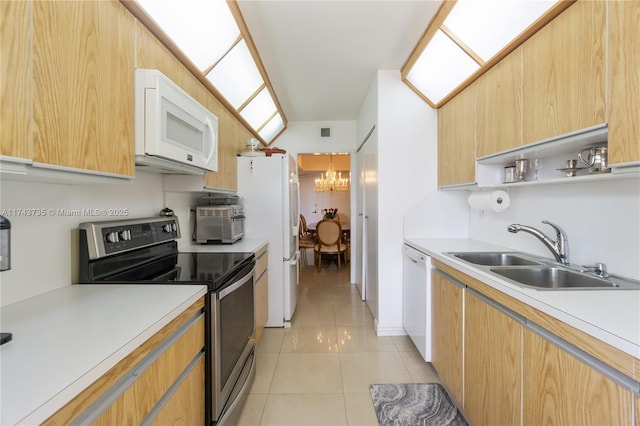 kitchen featuring a notable chandelier, white appliances, sink, and light tile patterned floors