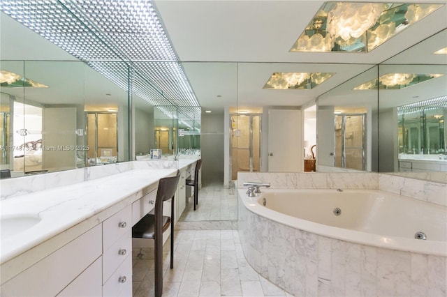 bathroom featuring vanity and separate shower and tub