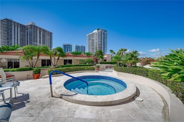 view of pool featuring a community hot tub and a patio