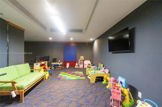 recreation room with dark carpet