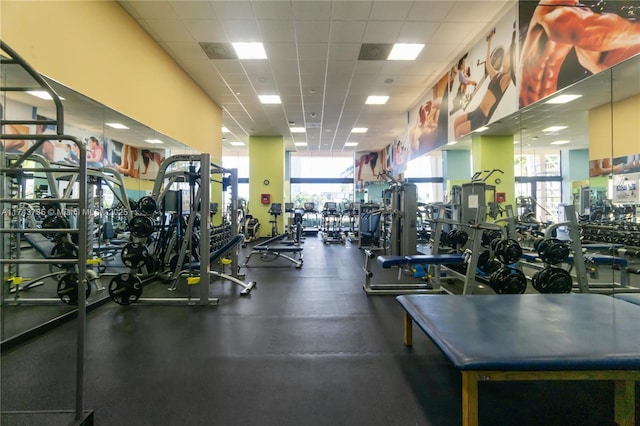 exercise room with a paneled ceiling