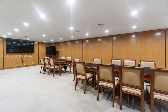 dining space featuring light carpet