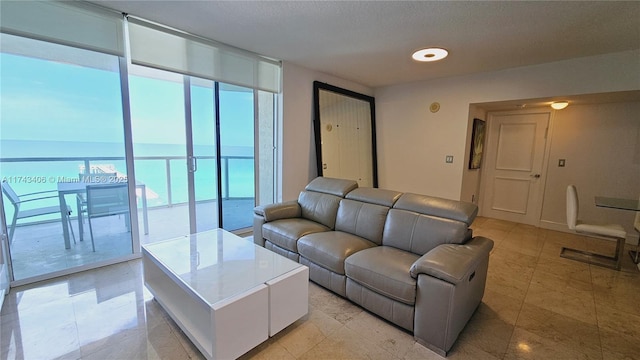 living room with floor to ceiling windows and a water view