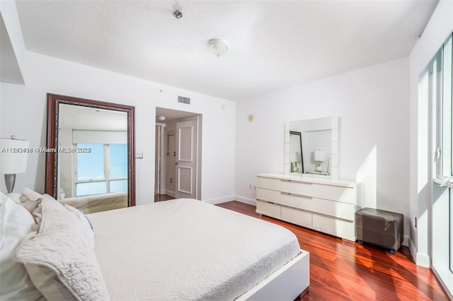 bedroom with hardwood / wood-style floors