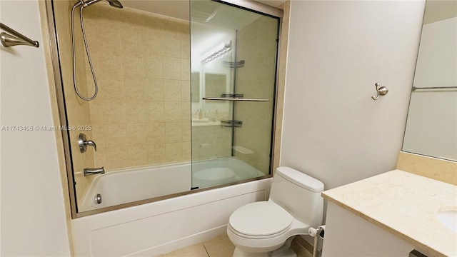 full bathroom featuring vanity, tile patterned flooring, bath / shower combo with glass door, and toilet