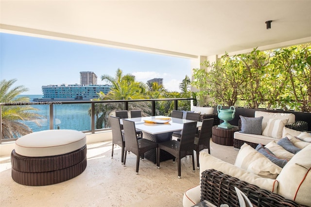 balcony with a water view and an outdoor hangout area