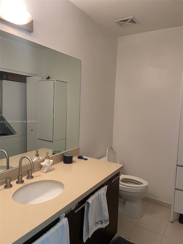 bathroom featuring tile patterned floors, toilet, and vanity