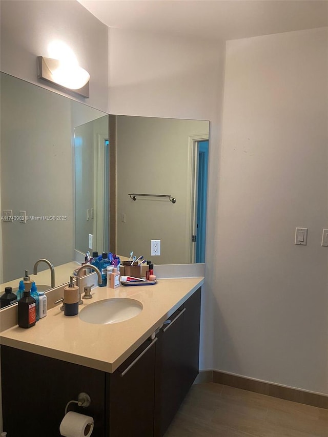 bathroom featuring hardwood / wood-style flooring and vanity