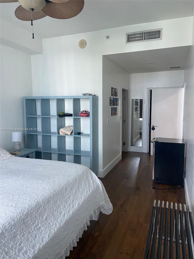 bedroom with dark hardwood / wood-style flooring