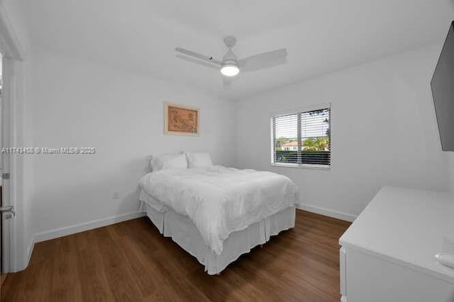 bedroom with ceiling fan and dark hardwood / wood-style flooring