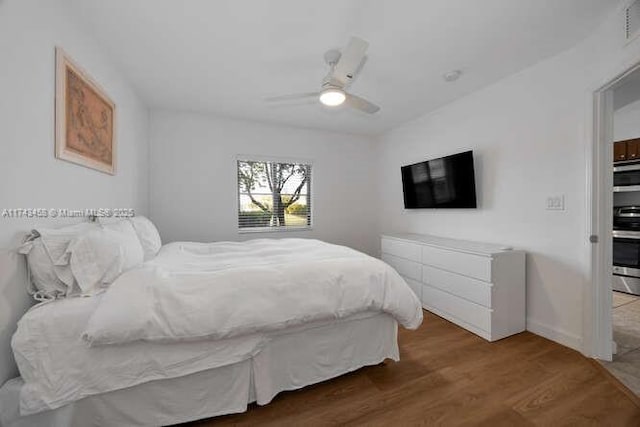 bedroom featuring hardwood / wood-style floors and ceiling fan