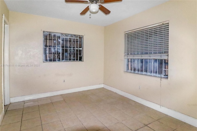 tiled empty room with ceiling fan