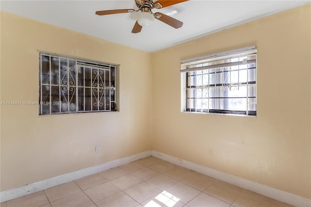 empty room with light tile patterned floors and ceiling fan