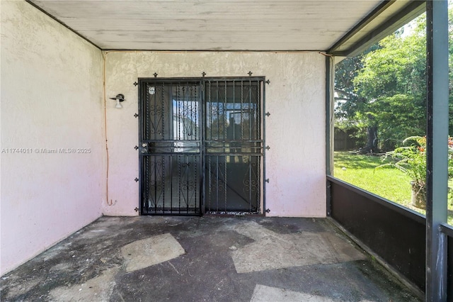 view of exterior entry featuring a patio area