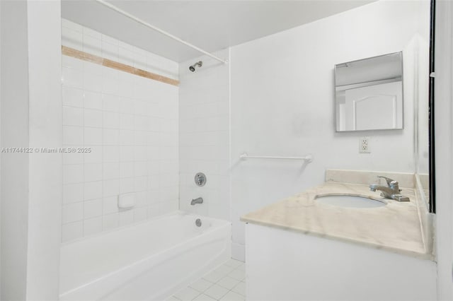 bathroom with tiled shower / bath combo, tile patterned floors, and vanity