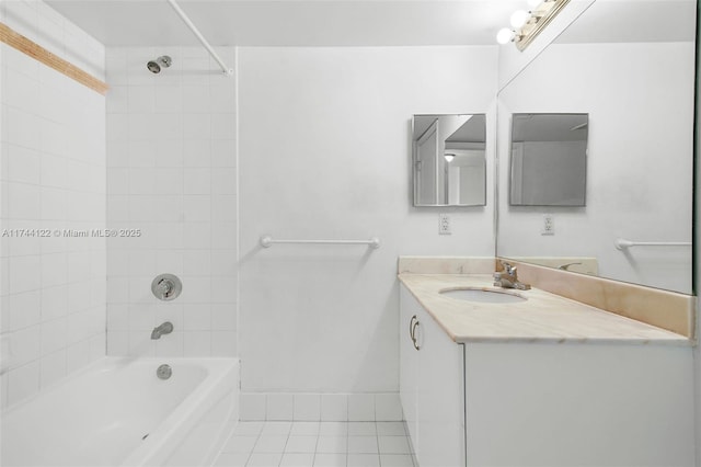 bathroom featuring tiled shower / bath combo, vanity, and tile patterned floors