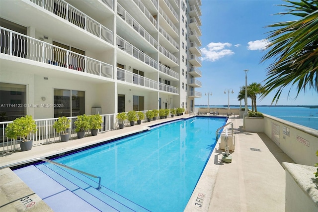 view of swimming pool with a water view