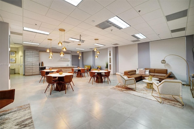 dining area with a paneled ceiling