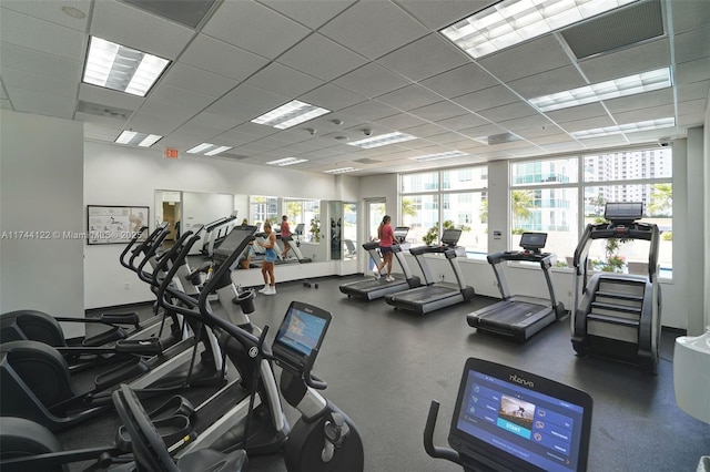 gym with a paneled ceiling