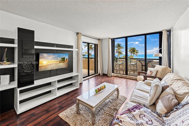 2555 Collins Ave Unit 403, Miami Beach, FL 33140 - living area with hardwood / wood-style flooring, a textured ceiling, and a wall of windows