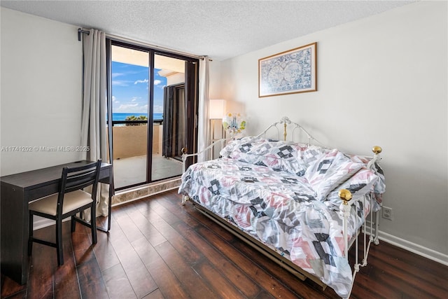 2555 Collins Ave Unit 403, Miami Beach, FL 33140 - bedroom with access to outside, wood-type flooring, floor to ceiling windows, a textured ceiling, and a water view