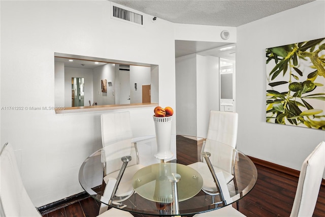 2555 Collins Ave Unit 403, Miami Beach, FL 33140 - dining area featuring wood finished floors, a textured ceiling, and baseboards