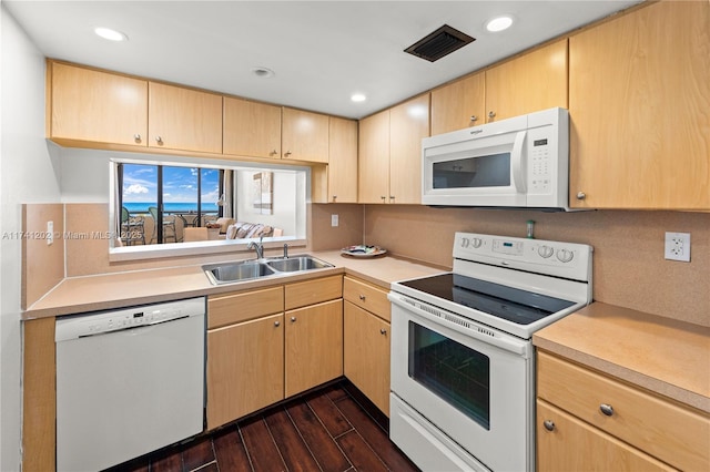 2555 Collins Ave Unit 403, Miami Beach, FL 33140 - kitchen featuring white appliances, a sink, light countertops, dark wood finished floors, and light brown cabinetry