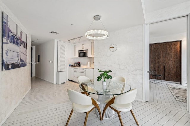 2201 Collins Ave Unit 811, Miami Beach, FL 33139 - dining room with a chandelier and rail lighting