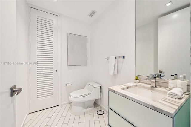 2201 Collins Ave Unit 811, Miami Beach, FL 33139 - bathroom with toilet, baseboards, and vanity