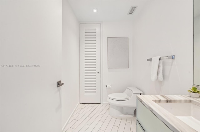2201 Collins Ave Unit 811, Miami Beach, FL 33139 - bathroom with vanity, toilet, and baseboards