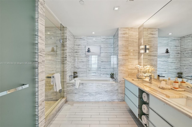 2201 Collins Ave Unit 811, Miami Beach, FL 33139 - bathroom featuring a garden tub, vanity, a shower stall, tile walls, and recessed lighting