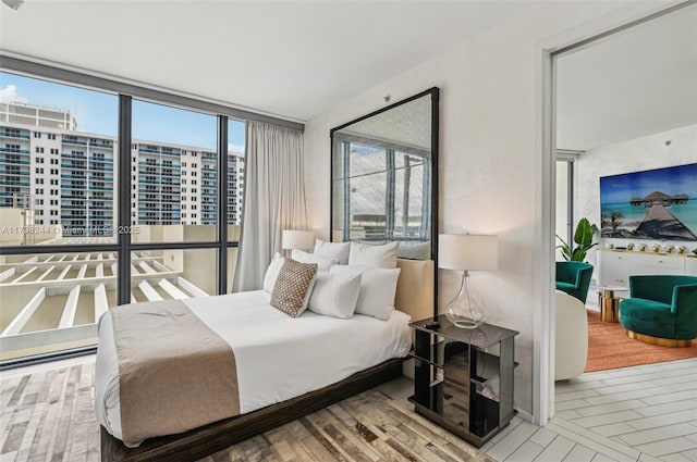 2201 Collins Ave Unit 811, Miami Beach, FL 33139 - bedroom with wood finished floors and a city view