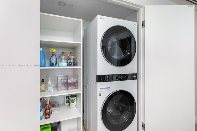 laundry area featuring stacked washer and dryer and laundry area