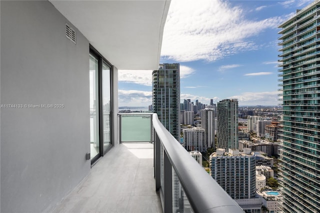 balcony with visible vents and a city view