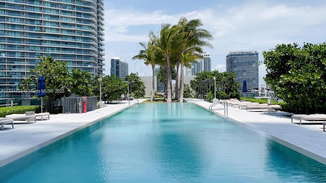 community pool featuring a view of city and a patio area