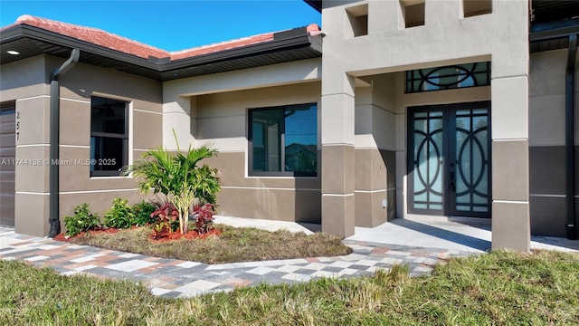 view of exterior entry featuring french doors