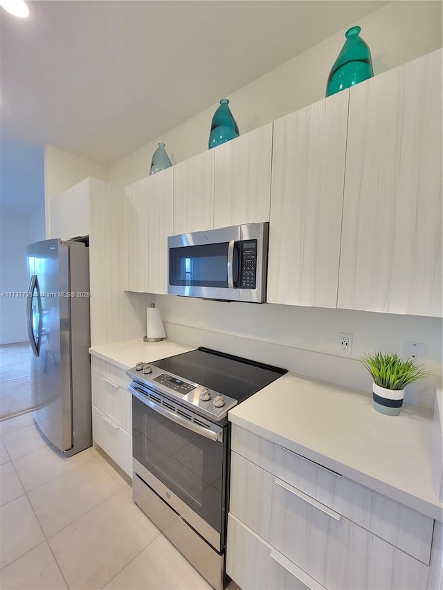 kitchen featuring light tile patterned floors and appliances with stainless steel finishes