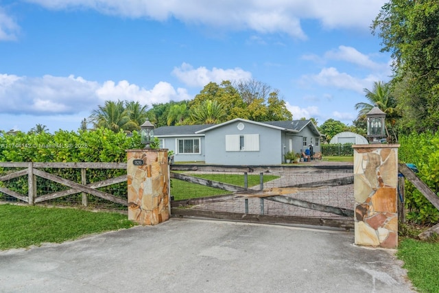 view of gate featuring a fenced front yard