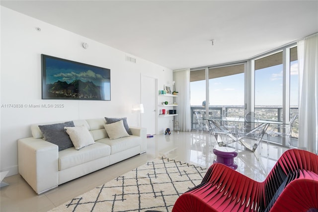 living room featuring floor to ceiling windows and light tile patterned flooring