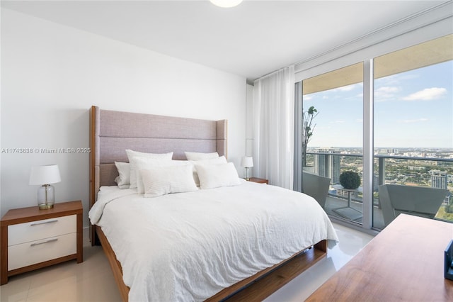 bedroom with expansive windows and access to outside