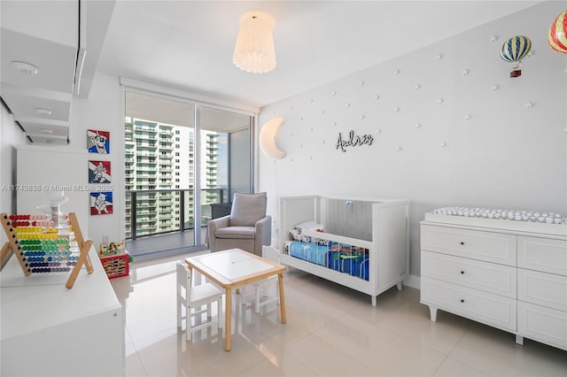 bedroom with light tile patterned floors and expansive windows