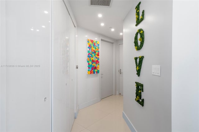 corridor featuring light tile patterned floors