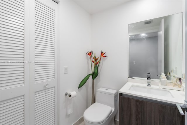 bathroom with vanity and toilet