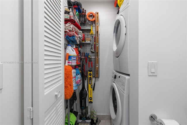 washroom with stacked washing maching and dryer