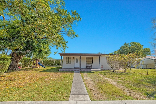 view of front facade featuring a front lawn, a playground, and a porch