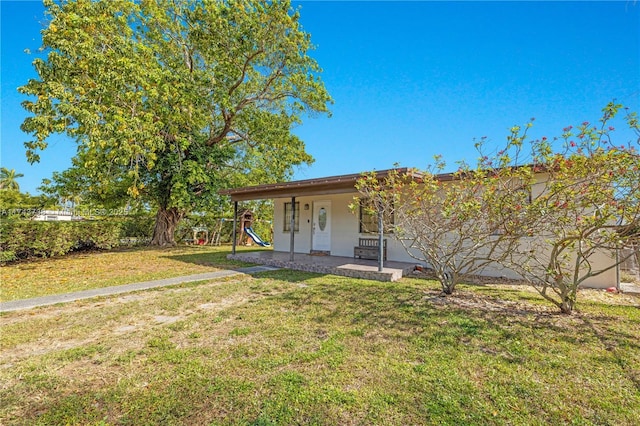 exterior space with a porch and a front lawn