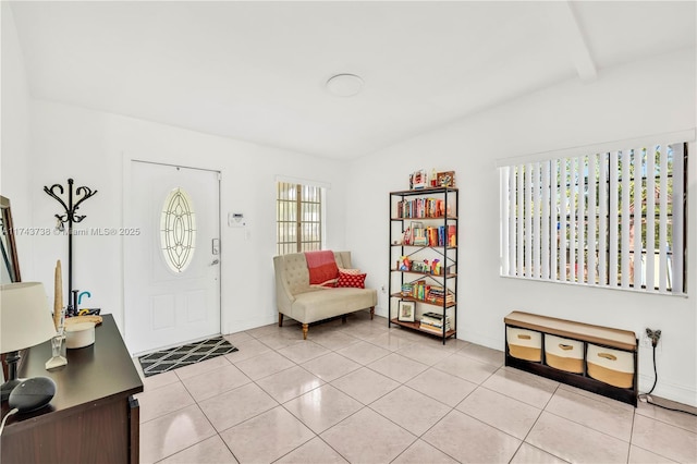 foyer entrance featuring vaulted ceiling with beams and light tile patterned floors