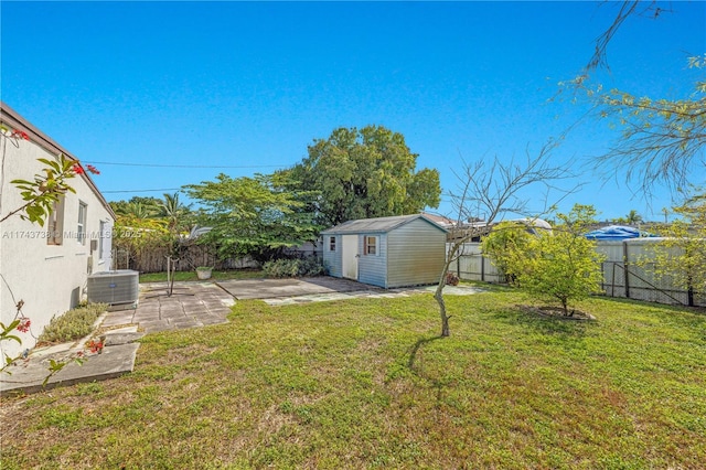 view of yard with cooling unit, a storage unit, and a patio area